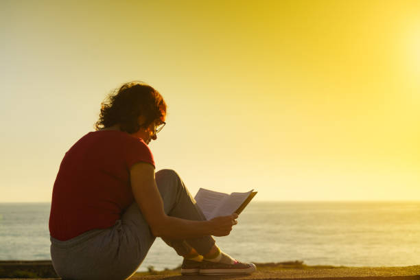 istock Woman on sea read book, relaxing 2155597476