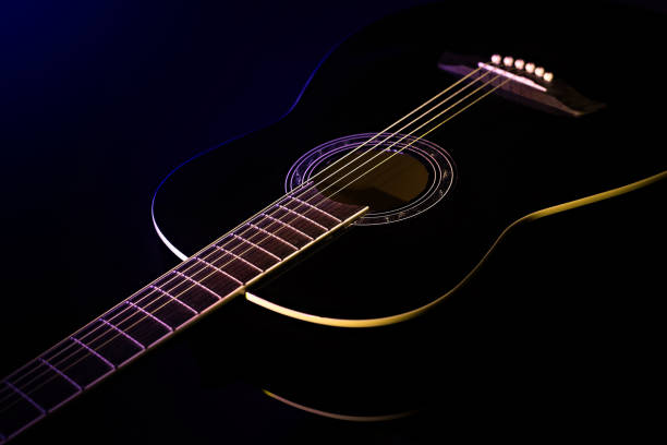A musicians playing an electric guitar, the image is close up on the hands and the atmosphere is quite warm and dramatic