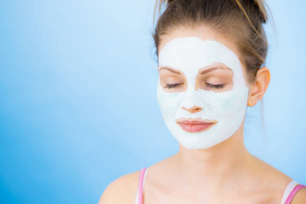 istock Girl with dry white mud mask on face 2155598318
