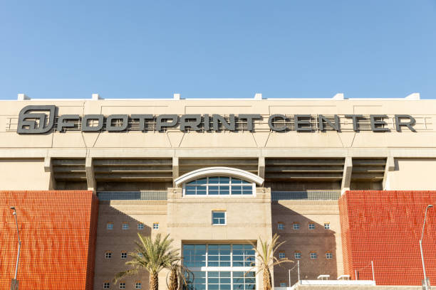 College Station, Texas USA July 31, 2015: Kyle Field at Texas A&M. The impressive statues of  football players and fans honoring the 12th man ie. the fans and players. This panoramic view highlights the stadium's unique architecture against a clear blue Texas sky.