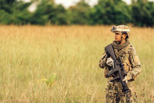 istock Armed with M16 rifles, they stand ready to engage the enemy, their training and discipline guiding their every move in the dense foliage. 2155601099