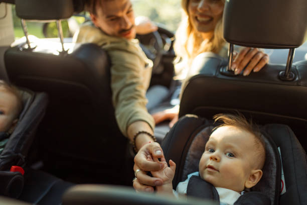 istock During a break from their road trip, a cute baby boy holds his father's finger. 2155601708