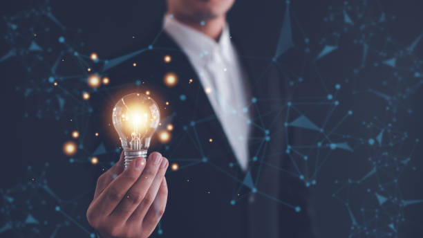 istock Idea innovation and inspiration concept.Hand of man holding illuminated light bulb, Idea innovation and inspiration concept.  creativity with bulbs that shine glitter, Concept for success. 2155603346