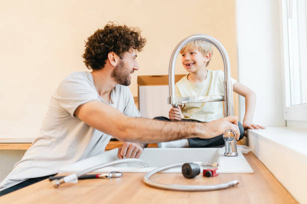 istock Father and son assembling kitchen furniture 2155603450