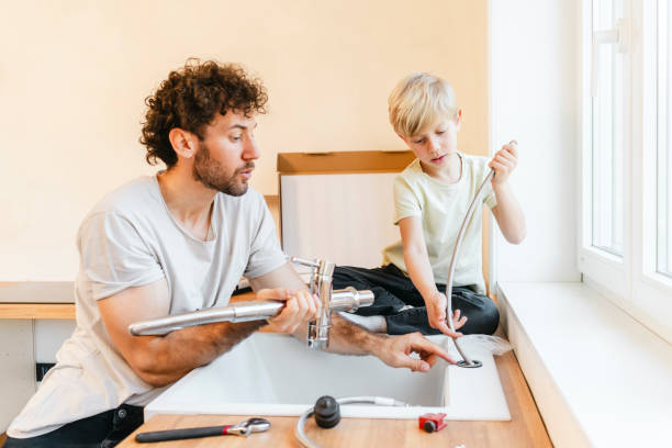 istock Father and son assembling kitchen furniture 2155603491