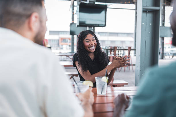 istock Friends enjoying outdoor dining at a picnic table on a sunny day 2155604815