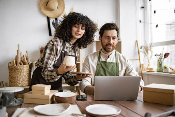 istock Caucasian couple of co-workers work on small pottery production business. 2155605421