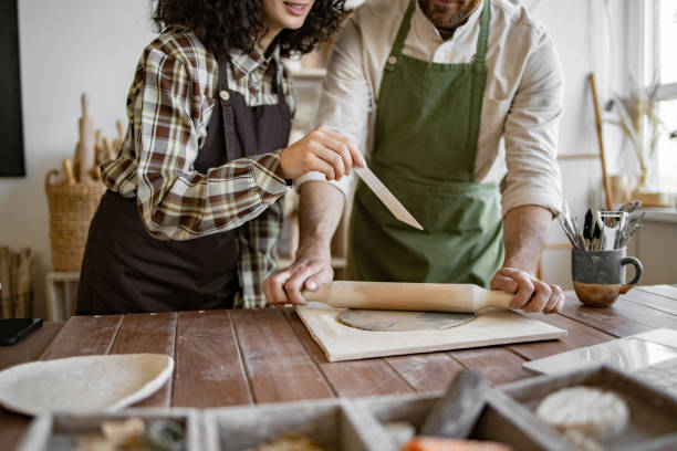 istock Couple working with clay at home pottery studio 2155605475