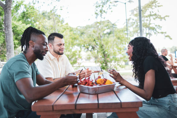 istock Friends enjoying crawfish outdoors at a picnic table in restaurant 2155605484