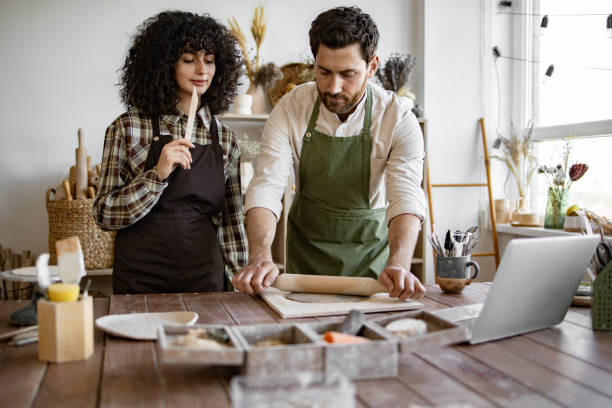 istock Man and woman working with clay in pottery studio 2155605490
