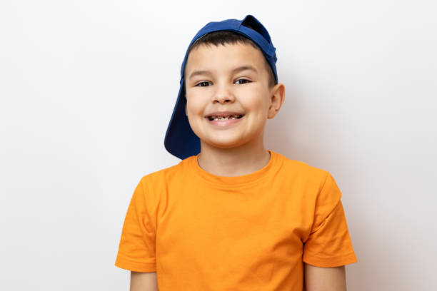 istock The guy smiles slyly, showing his teeth. Sincere children's emotions. 2155605532