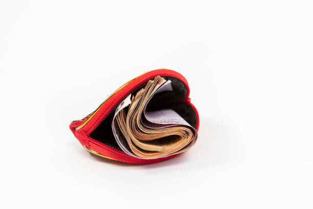 istock Stack of money in a small red money pouch on a white background 2155605753