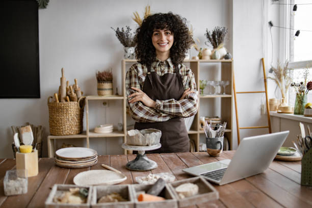 istock Female artisan standing confidently in pottery studio with folded arms 2155607525