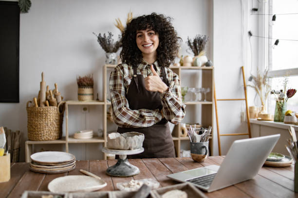 istock Female artisan giving thumbs up in pottery studio 2155607529