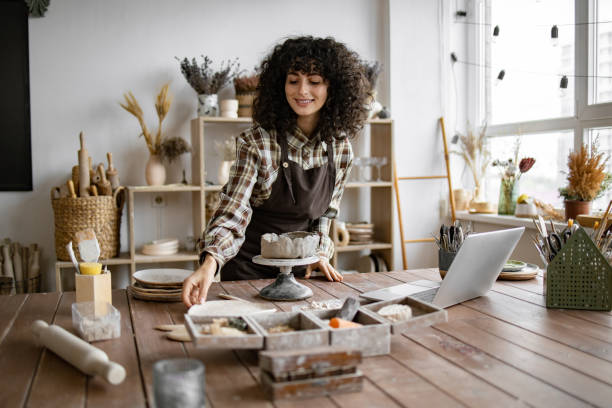 istock Female artisan working with clay in art studio 2155607533
