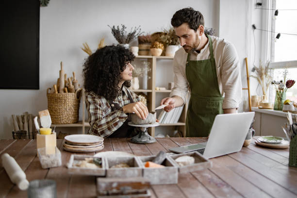 istock Pottery class with male and female artists working together 2155607571