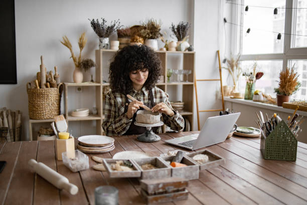 istock Female artist creating pottery in cozy studio with natural light 2155607582