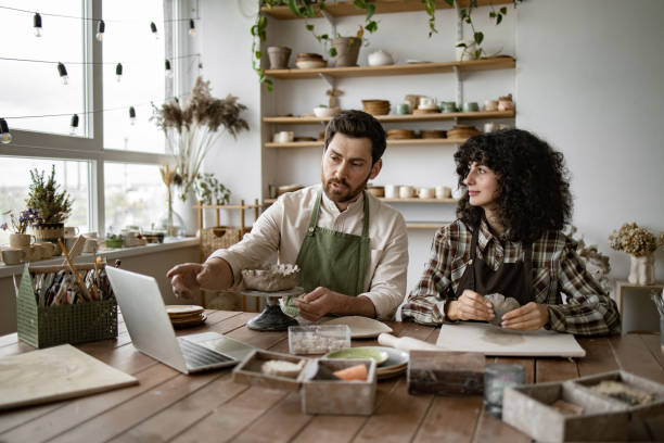 istock Man and woman learning pottery through an online video course 2155607627