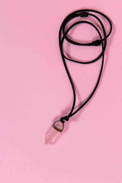 istock Pink gemstone with black cord necklace choker on pink background 2155607995