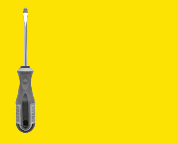 Carpenter holding screwdriver, tool for repair and maintenance. Yellow background with space for text in banner. Business promotion for builder, mechanic services with screw driver and handle.
