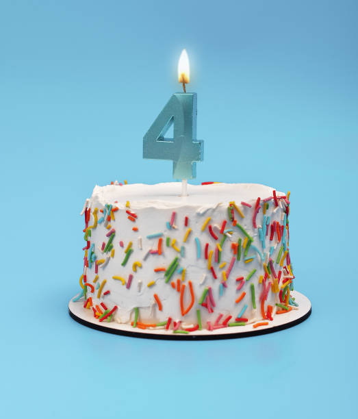 istock Cake with four candles for 4th birthday party. Happy celebration with blue white background. 2155609203