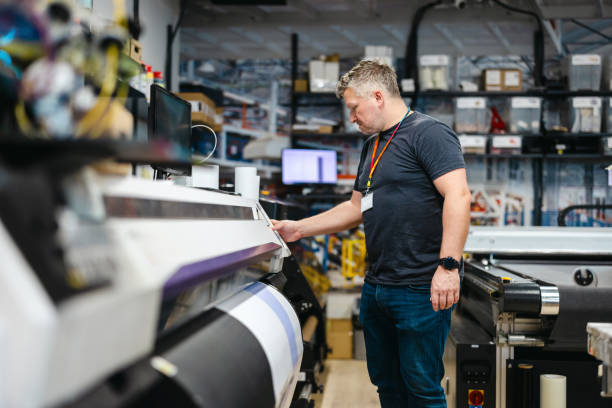 istock Man working in a printing factory 2155612130