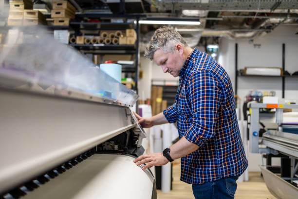istock Man working in a printing factory 2155612153
