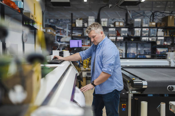 istock Man working in a printing factory 2155612157