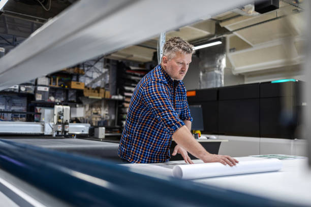 istock Man working in a printing factory 2155612172