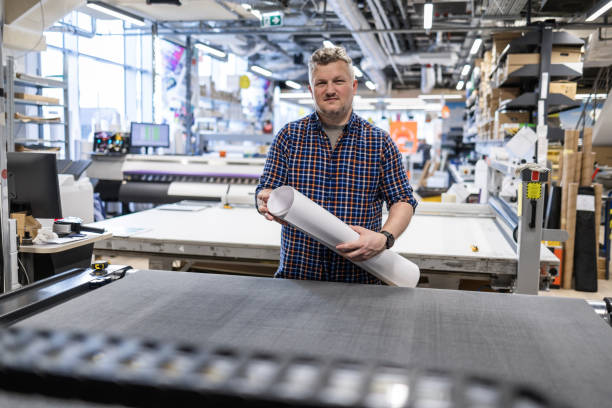 istock Man working in a printing factory 2155612173