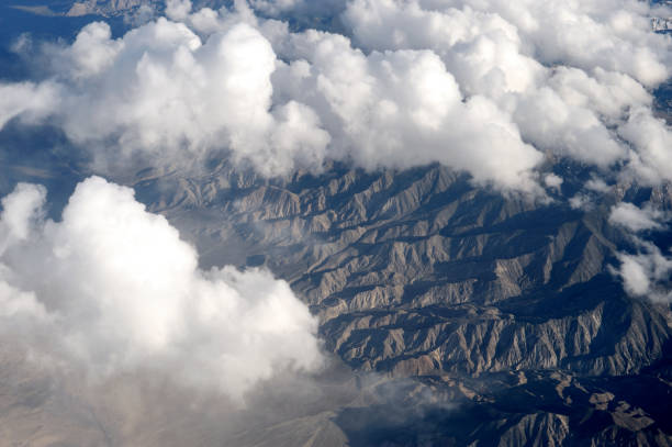 aerial view of mountain ranges with white cloud on top