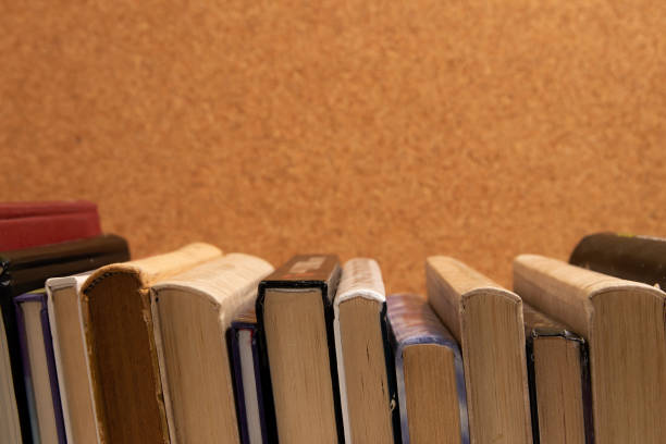 istock Hardcover books on a corkboard background 2155615224