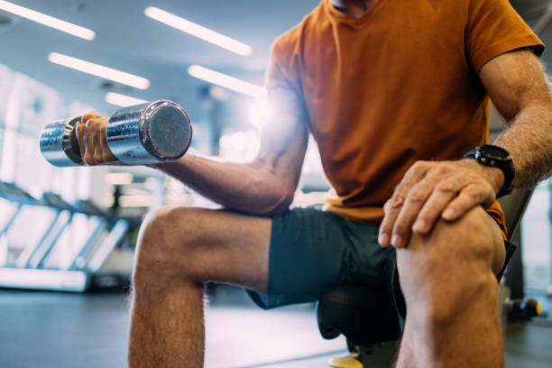 istock Man Lifting Dumbbell in Gym for Strength Training Workout 2155616070