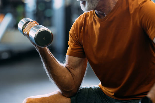 istock Senior Man Working Out with Dumbbell in Gym 2155616081