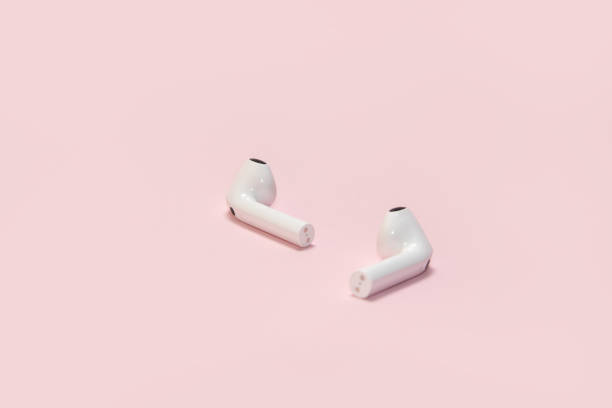 istock Wireless headphones on a pink background 2155616559