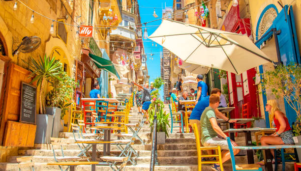 Street summer cafe in Valletta old town, Malta Valletta, Malta - 2 May, 2024: Street summer cafe in Valletta old town. People sitting in a cafe. busy restaurant tables stock pictures, royalty-free photos & images