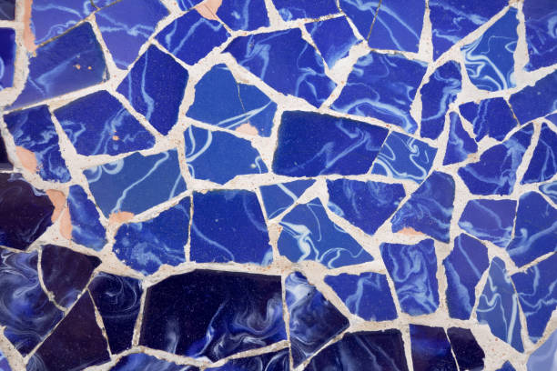 The glass mosaic in the public park features intricate patterns and a vibrant color palette, inviting visitors to admire its artistic beauty while enjoying outdoor activities.
