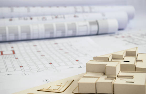 Architectural plan on desk with some office and construction supply and equipment