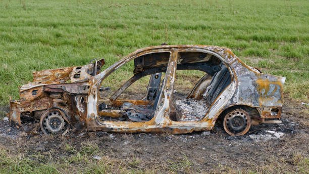 istock Burned down car in the field. Full destroyed vehicle. 2155617205
