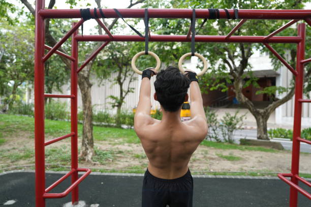 istock Asian man practicing gymnastics doing gymnastics bar and hoop exercises and stretching and resting for sports. 2155617969