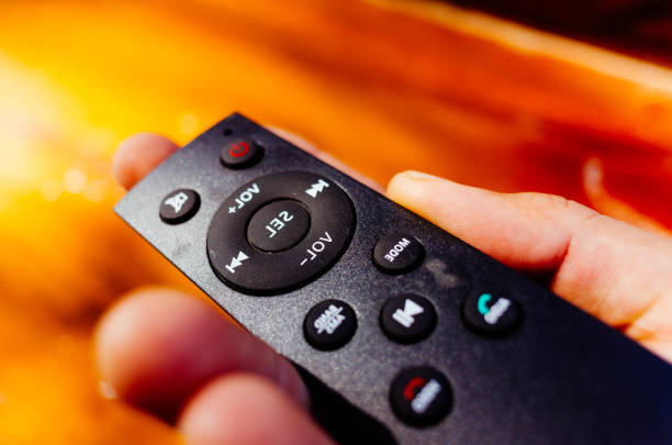 A detailed close-up stock photo of a smart TV remote placed on a wooden table. The image highlights modern design, sleek buttons, and a minimal aesthetic  perfect for technology, home entertainment, smart devices, and lifestyle-related projects.
