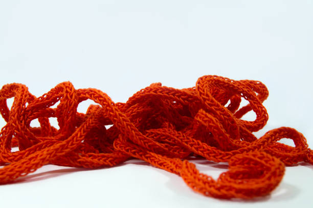 Bright orange spool knitted cord isolated