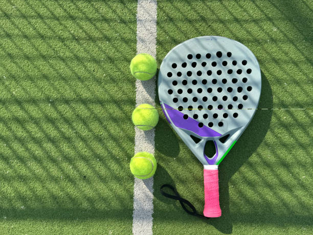 istock paddle tennis racket and balls on court 2155619785