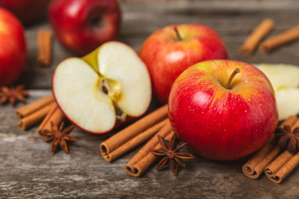 istock Apples with cinnamon on a textured wooden background. Fragrant red spiced apples with cinnamon sticks and star anise. Apple slices with spicy spices. Place for text. Copy space. Harvesting. Fruits. 2155620262