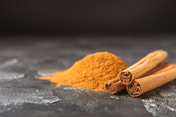 istock Ceylon cinnamon.Cinnamon sticks on a textured wooden background. Cinnamon roll and powder. Spicy spice for baking, desserts and drinks. Fragrant ground cinnamon. Close-up. Place for text. copy space 2155621041