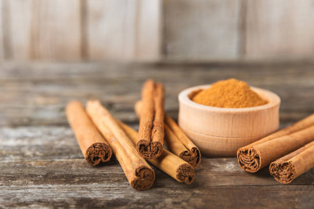 istock Ceylon cinnamon.Cinnamon sticks on a textured wooden background. Cinnamon roll and powder. Spicy spice for baking, desserts and drinks. Fragrant ground cinnamon. Close-up. Place for text. copy space 2155621051