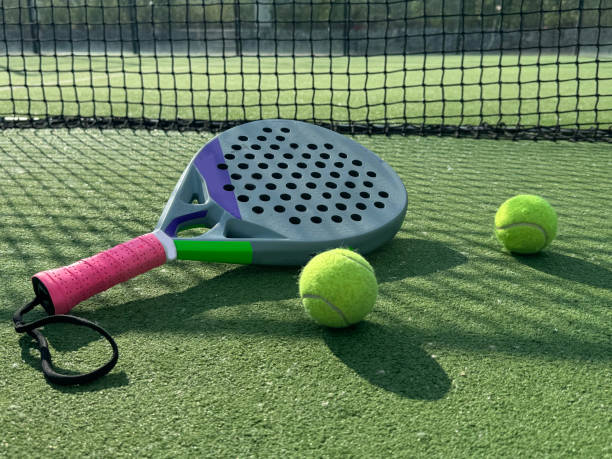istock Paddle tennis racket, ball and net on the grass 2155621062