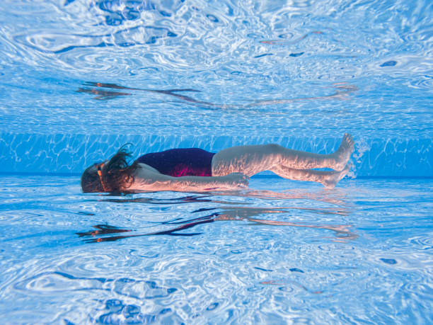 Little girl having fun swimming underwater