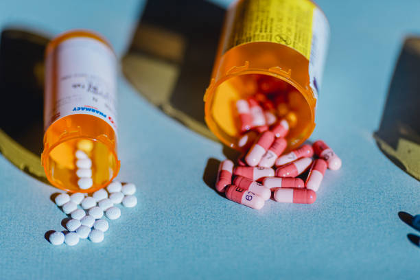 istock Open Pill Bottles and Medicine on Blue Background 2155622789