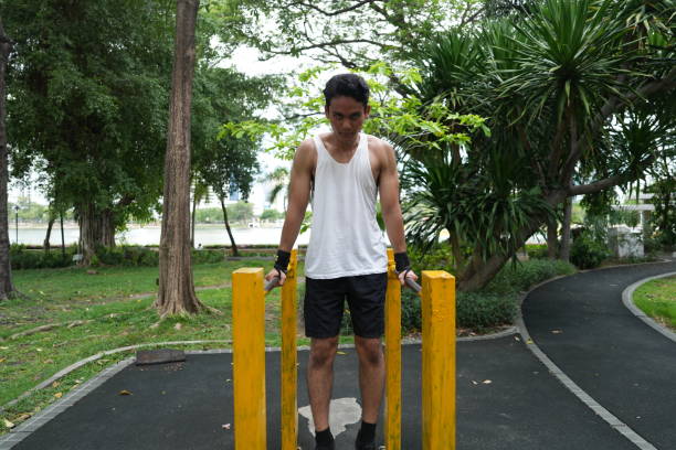 istock Asian man practicing gymnastics doing gymnastics bar and hoop exercises and stretching and resting for sports. 2155624027